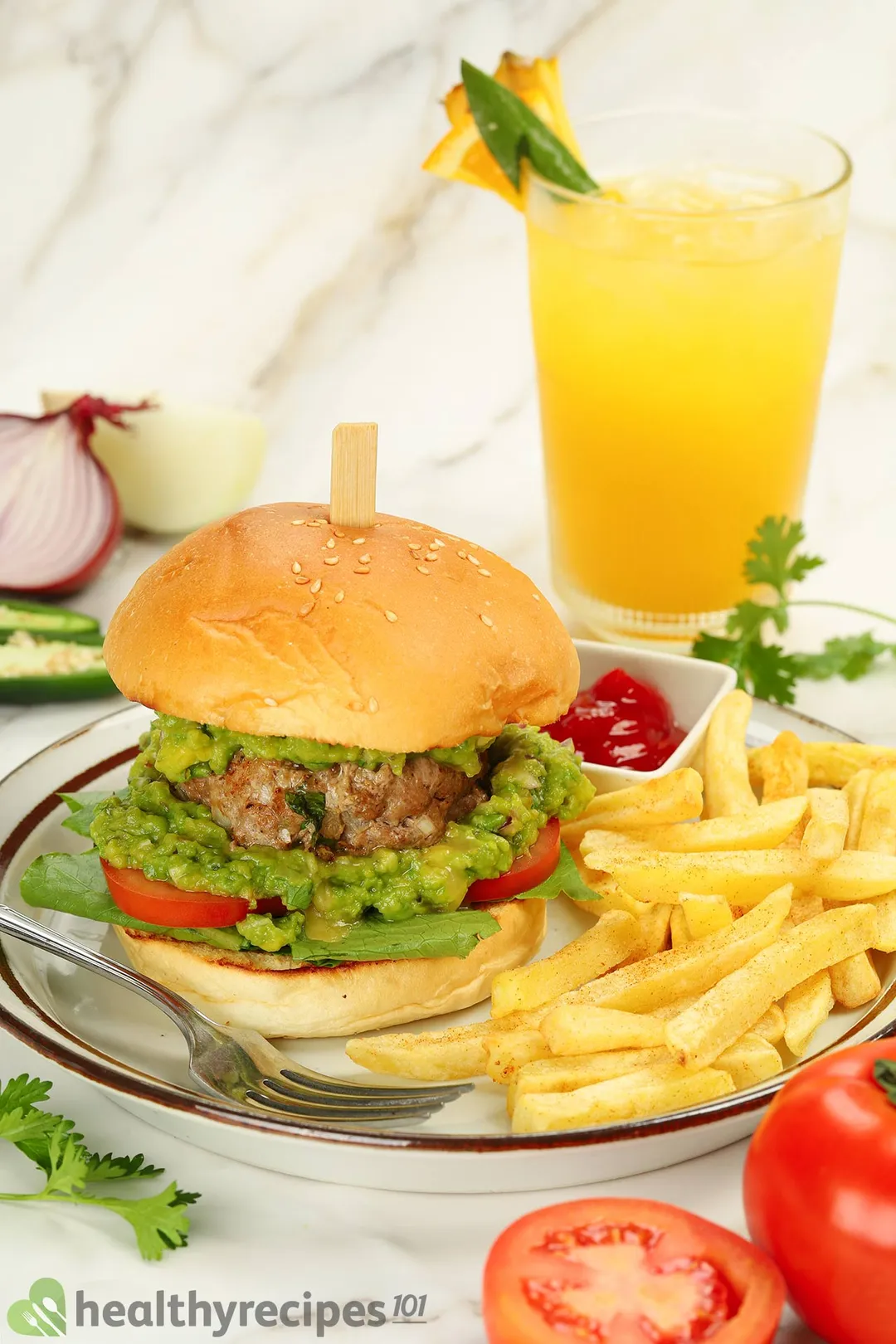 a burger on a plate with french fries and a fork, decorated with a glass juice, tomato