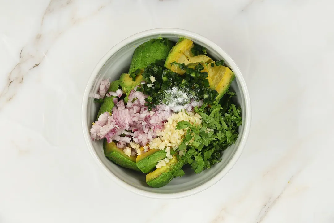 avocado, chopped red onion, chopped garlic, chopped parsley and salt in a bowl