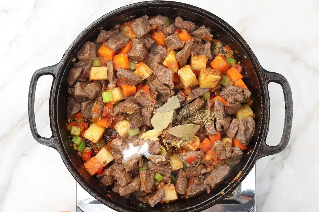 7 Return the browned beef to the pot along with the spices Stir