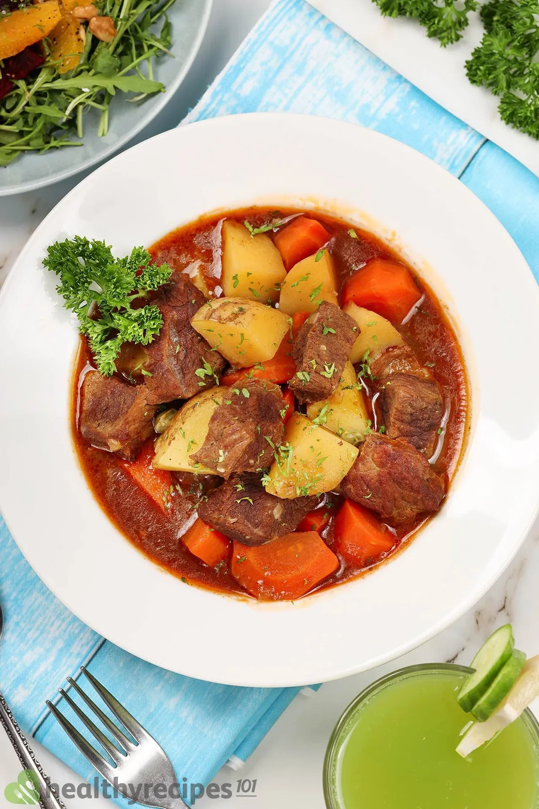 a plate of beef stew with potatoes