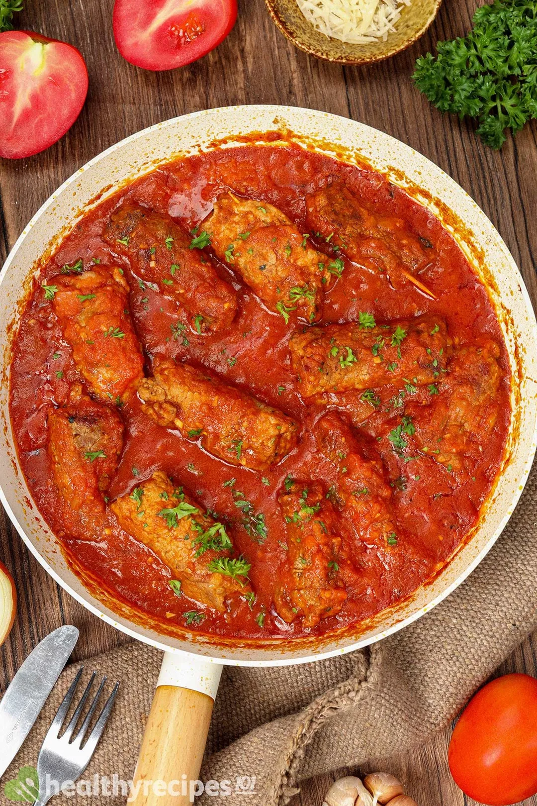 top view of a skillet of cooked beef braciole