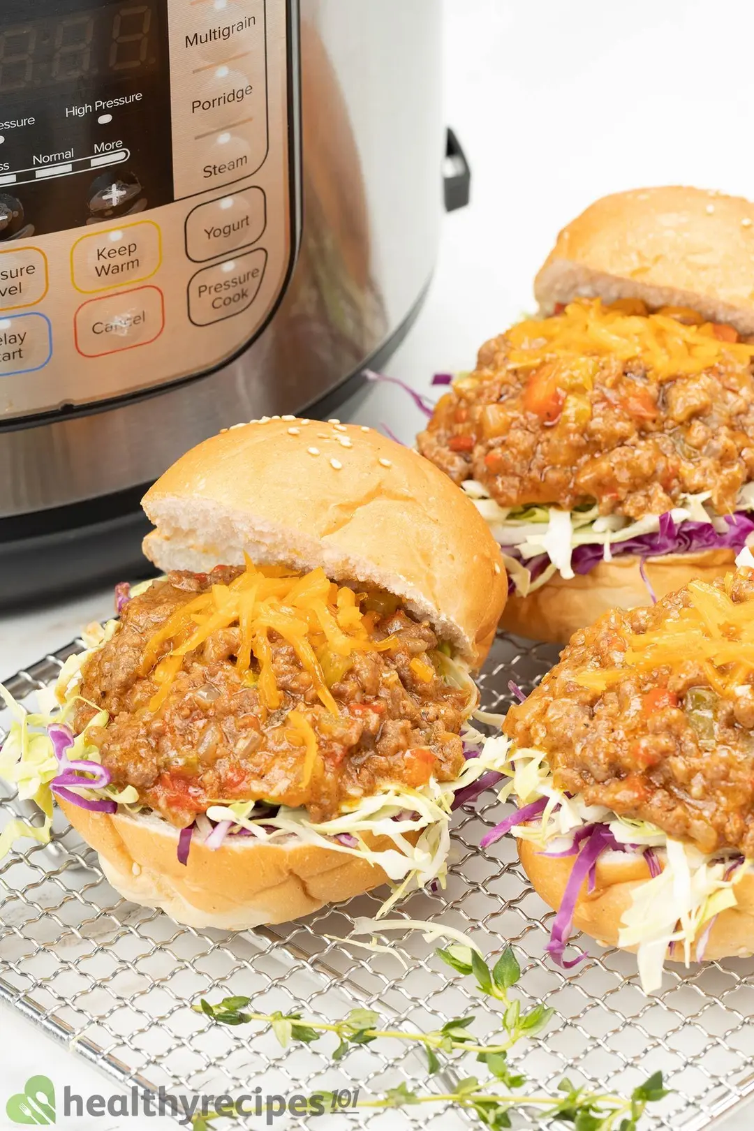 three burger with cooked ground beef beside an instant pot