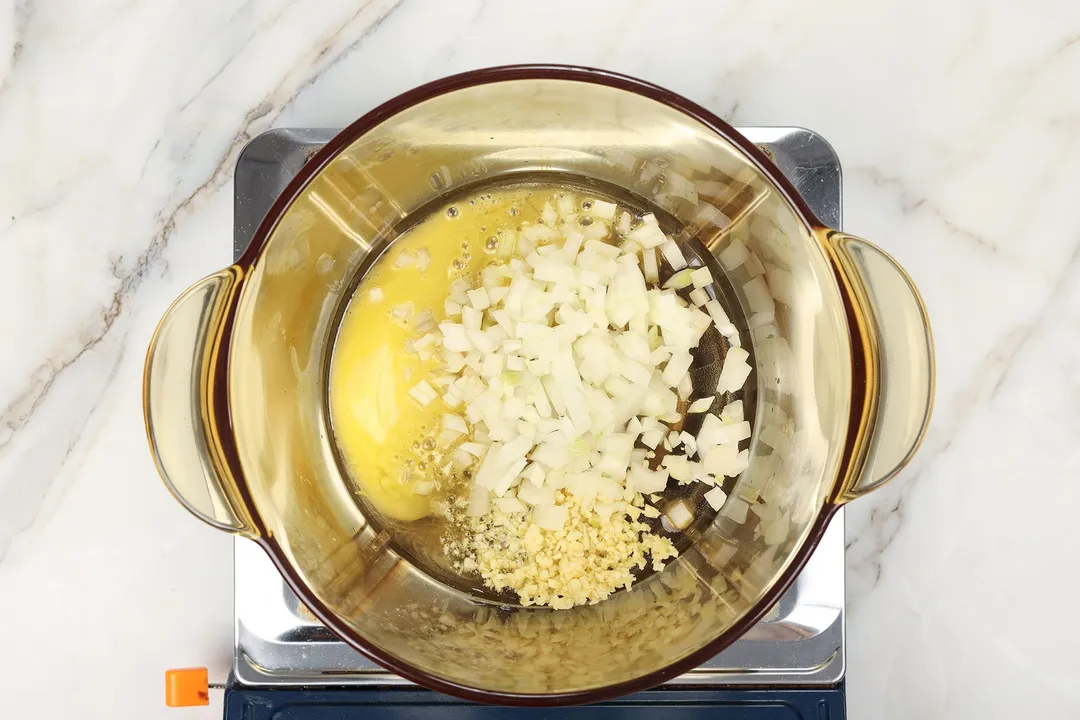 cooking diced onion in a pot