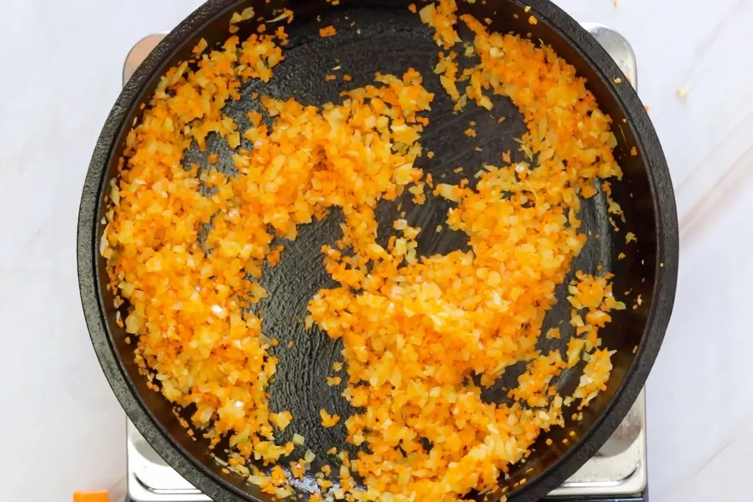 chopped carrot on a cast iron skillet