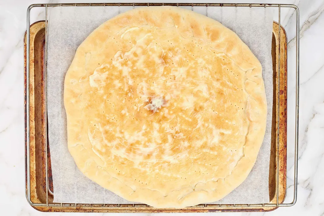 Spread mayonnaise over the base of the pizza dough