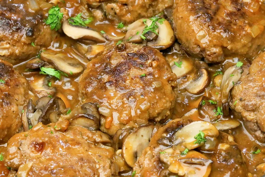 cooked beef patties with mushroom and sauce