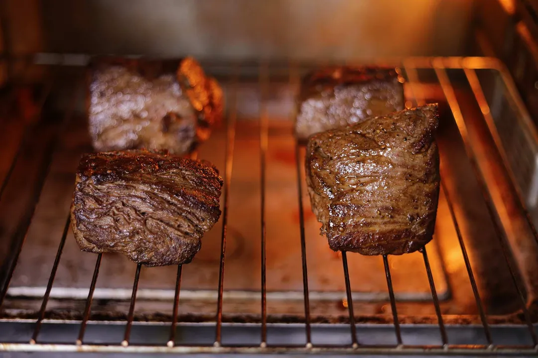 four beef tenderloin on wire rack in an oven