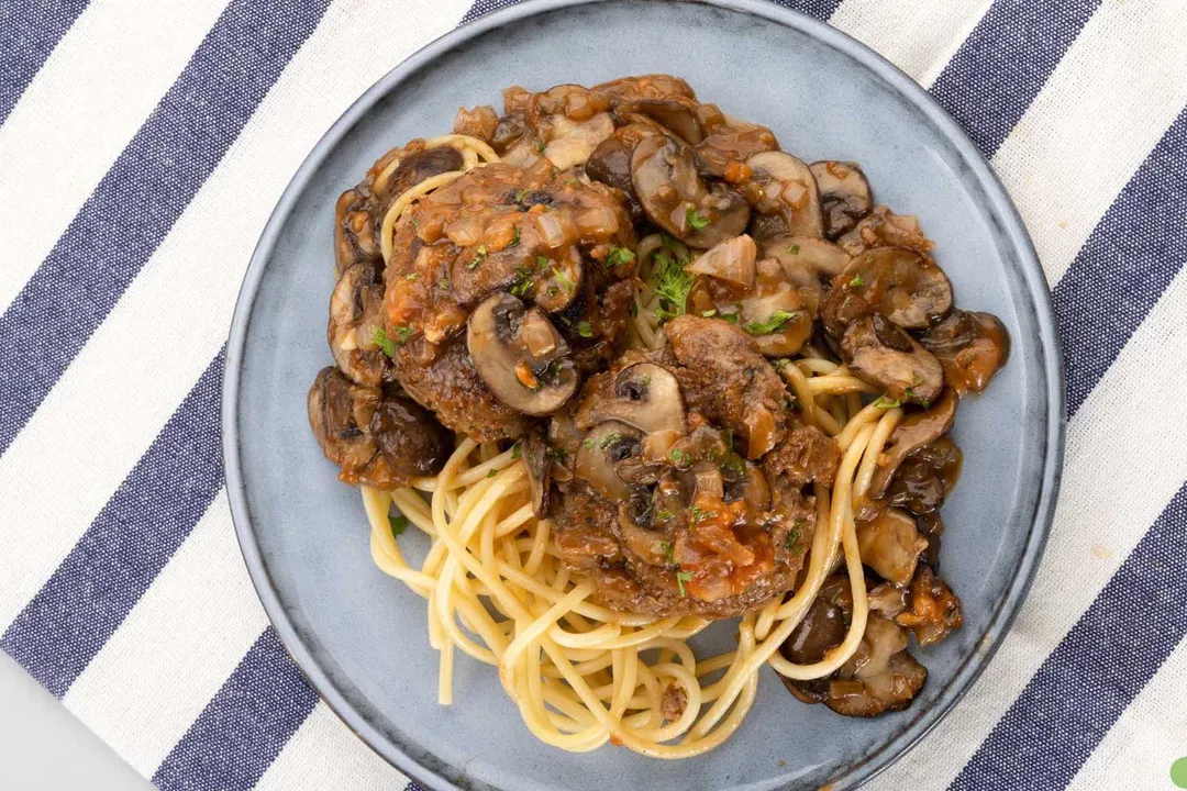 a plate of Salisbury Steak with pasta