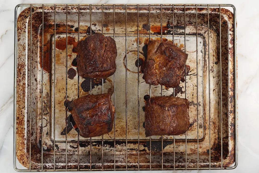 cooked beef tenderloin on a wire rack on a baking tray