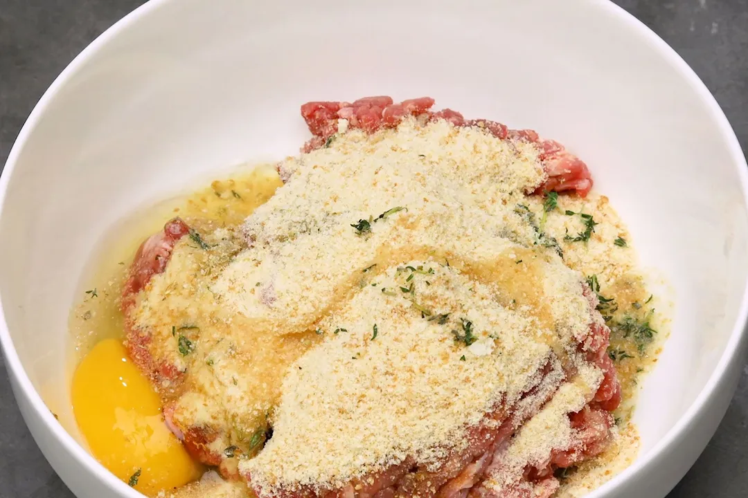 bread crumbs, ground beef, beaten egg and thyme in a bowl