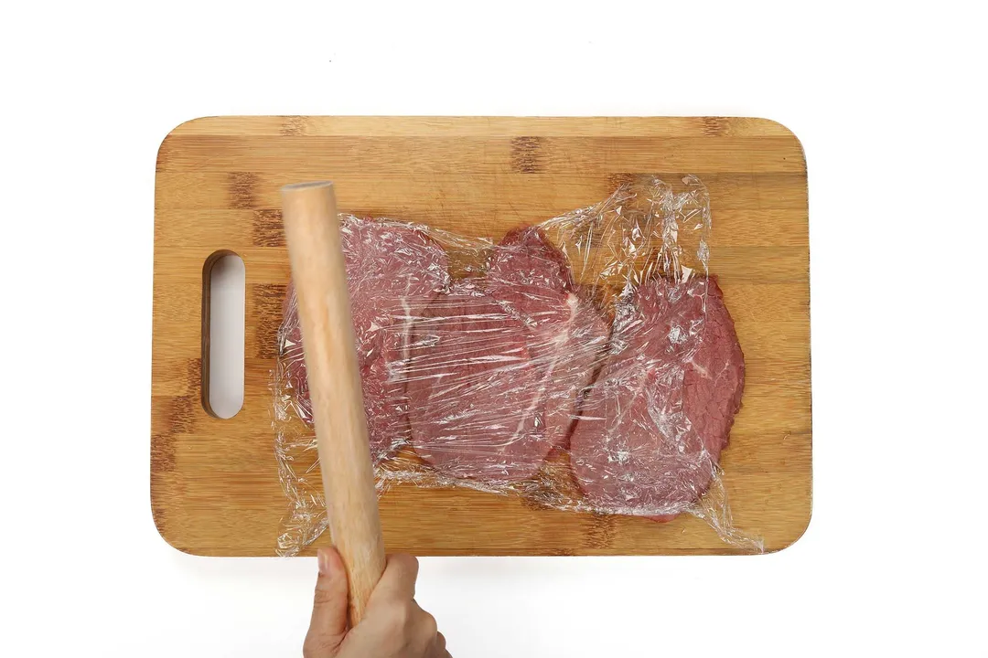 tenderize the beef on a cutting board