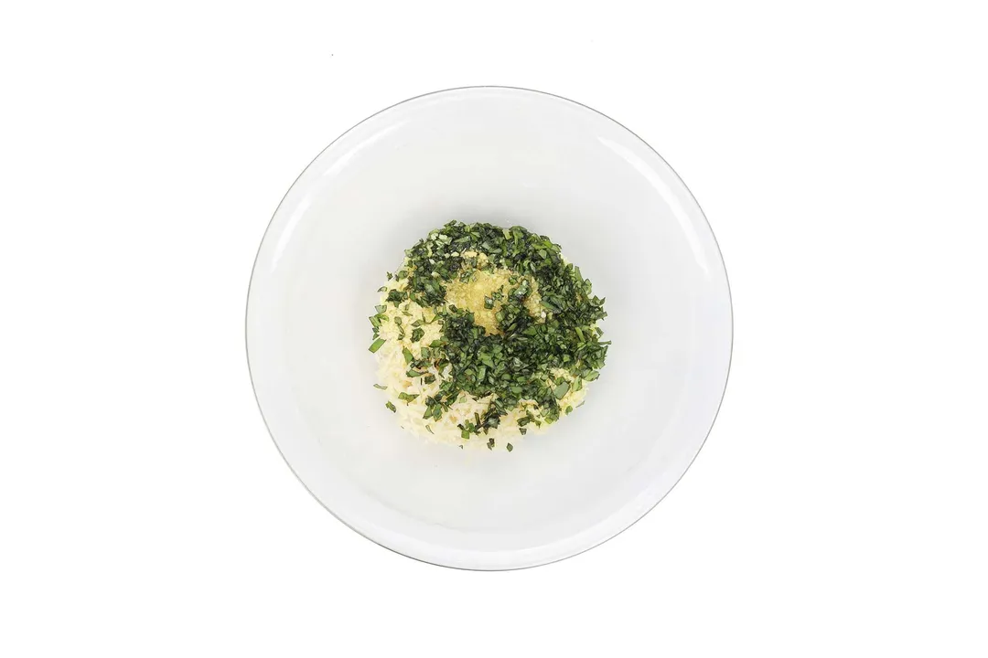 parmesan, parsley, panko breadcrumb and olive in a glass bowl