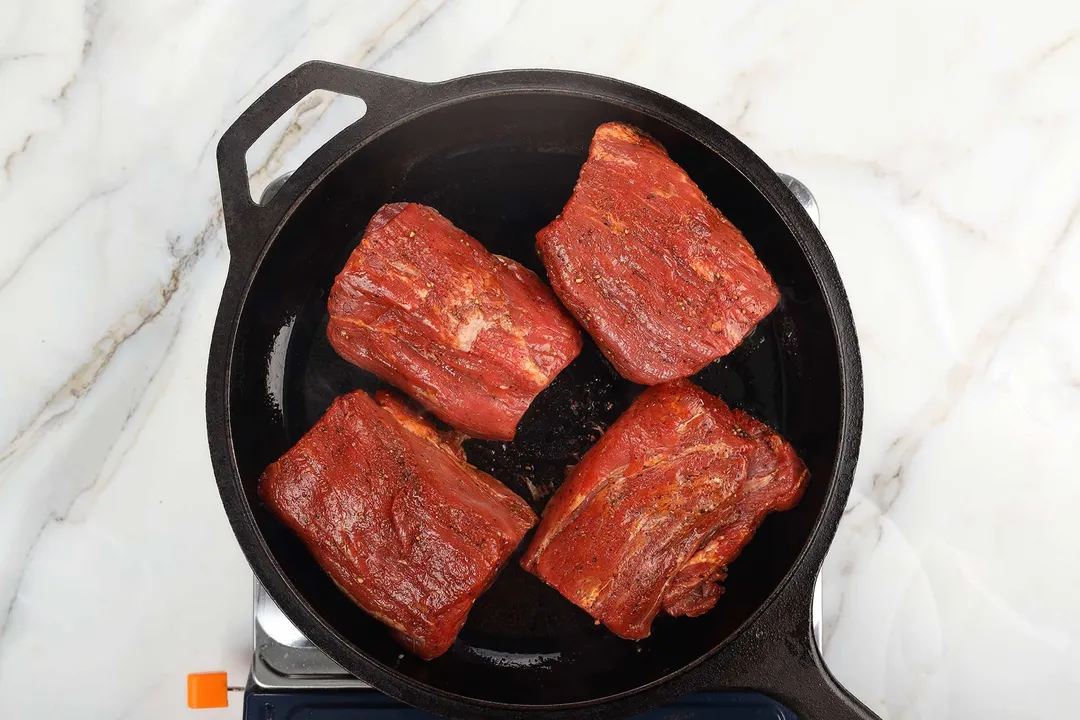 four beef tenderloin in a cast iron skillet