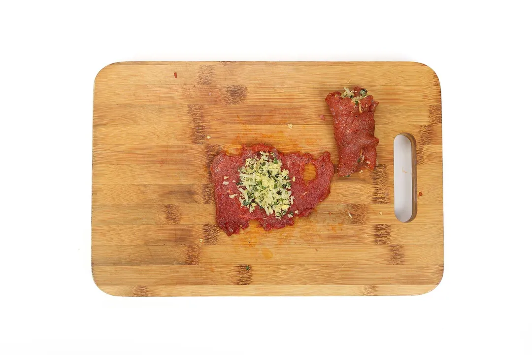 sliced beef and filling on a cutting board