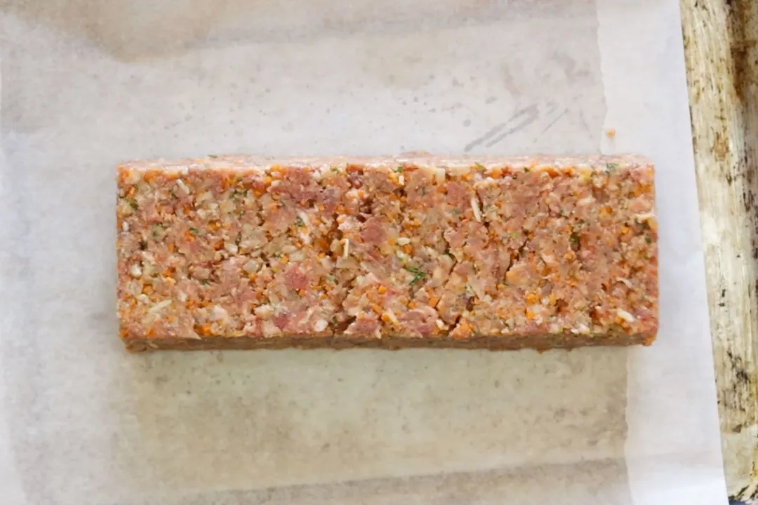 formed ground beef mixture on a baking sheet
