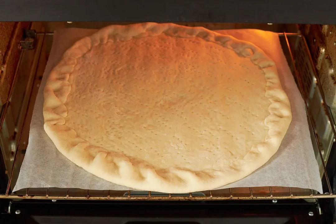 baking pizza dough in oven