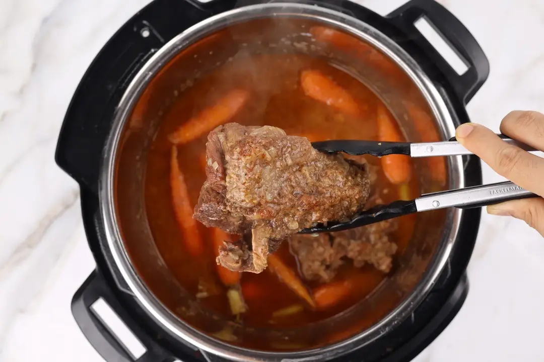 Tear the beef in a bowl and reduce the broth