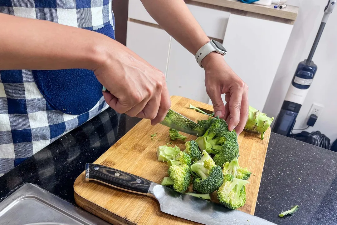 cut broccoli florets in a cutting board