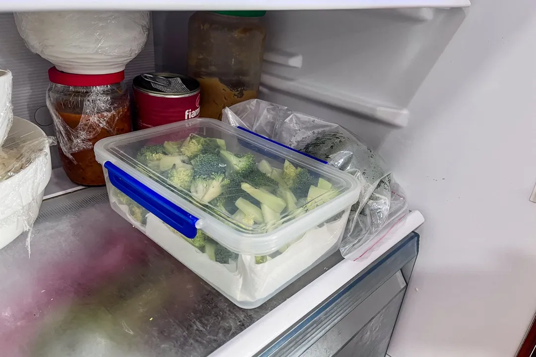 broccoli florets in a food container in a fridge