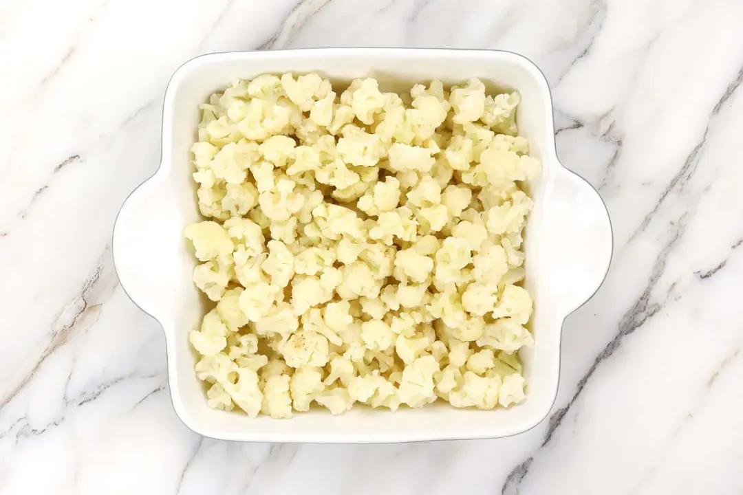 Add the cauliflower to the baking dish