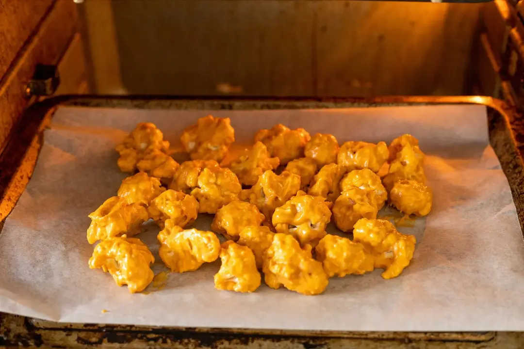 Coat the cauliflower and bake for buffalo tacos