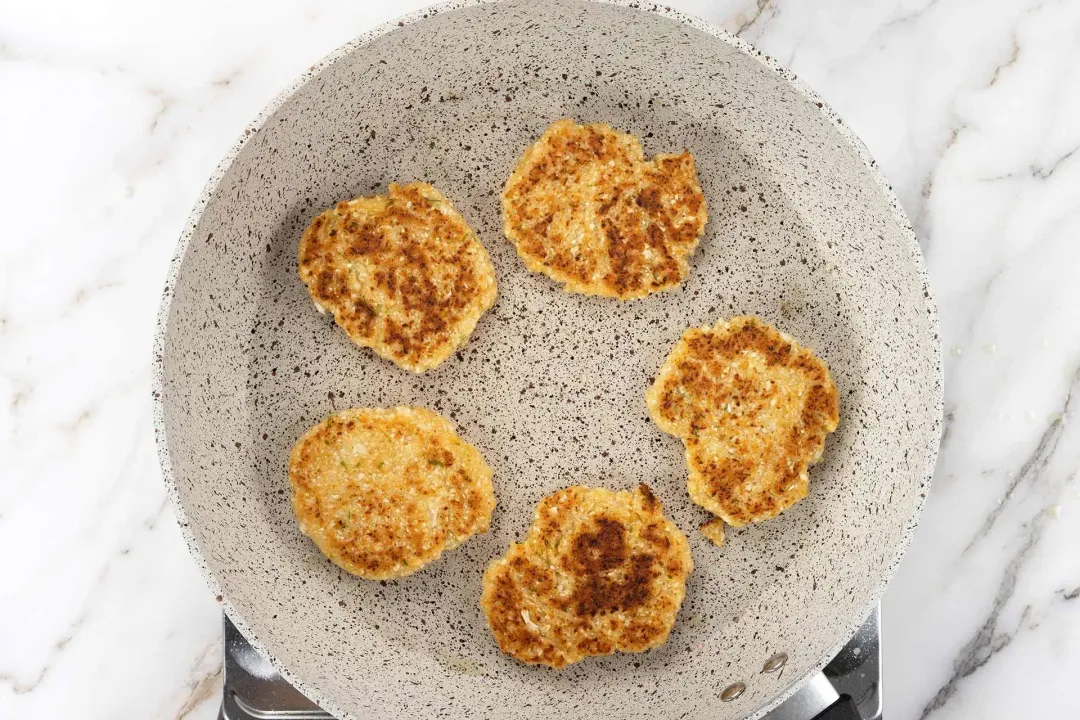 Flip the patties halfway and cook until golden brown at the edges and on both sides