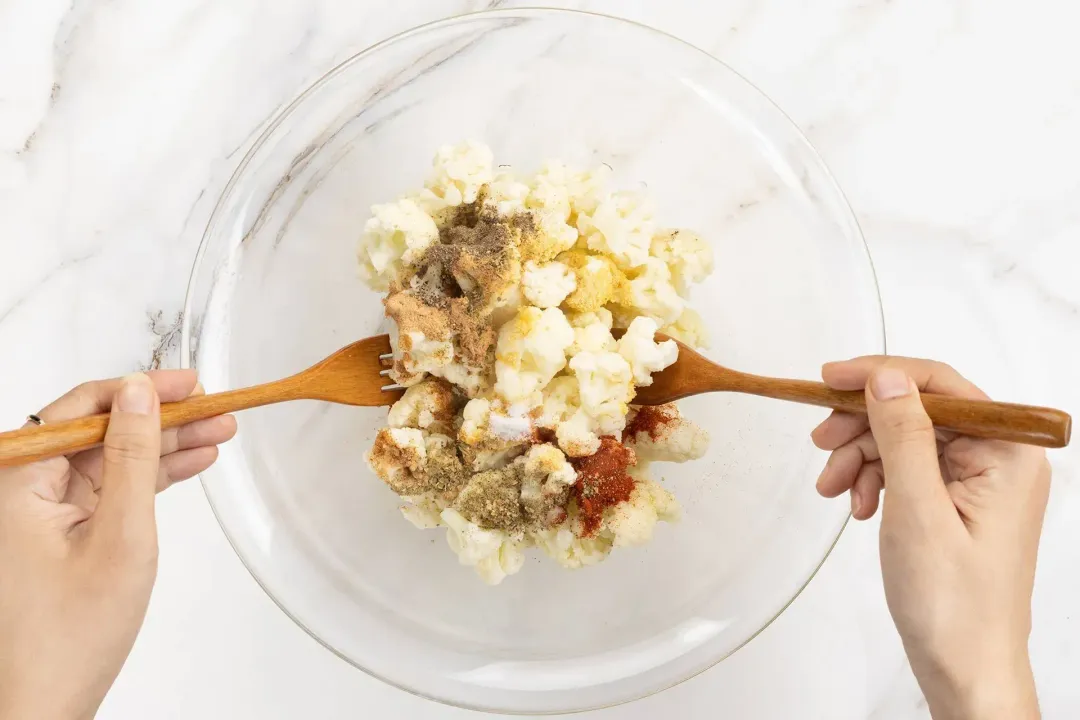 Mix cauliflower with seasonings and spices