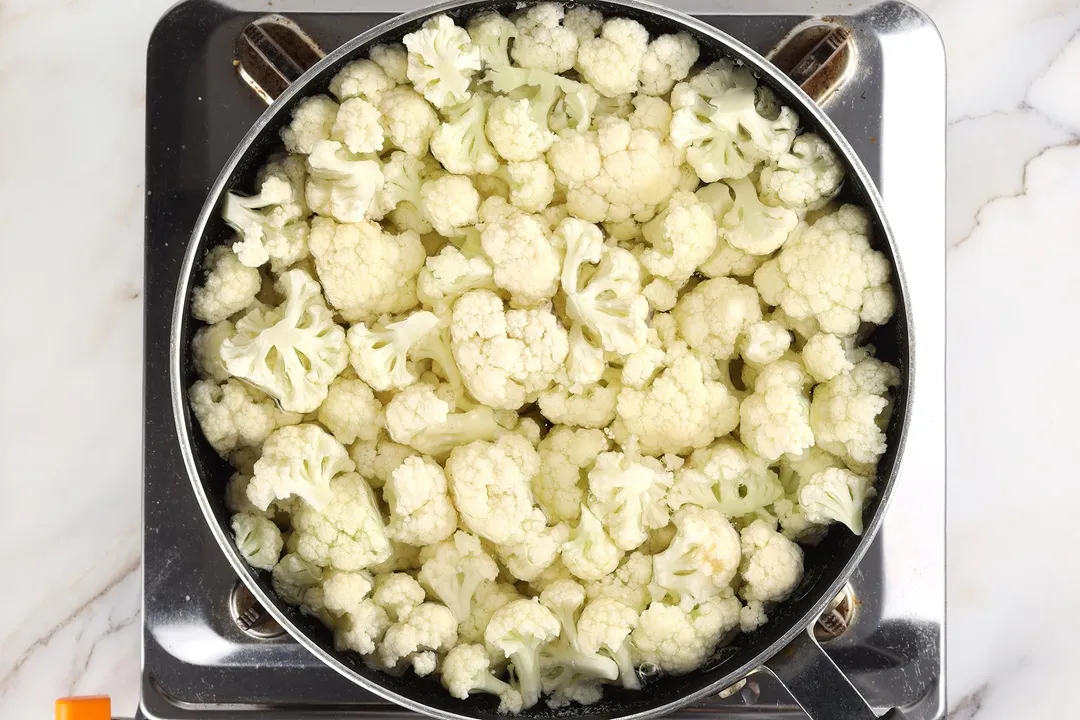boiling cauliflower florets in a skillet