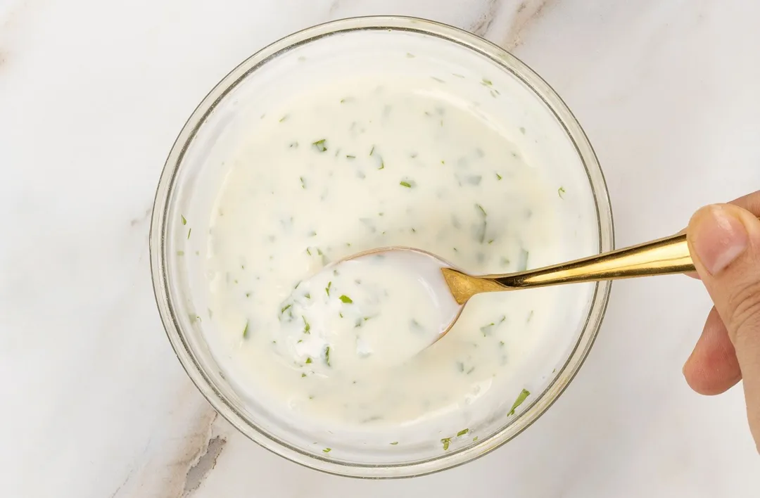 making white dressing for salad in a bowl