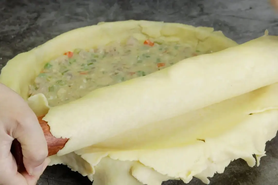 12 Put the top crust over the chicken pot pie