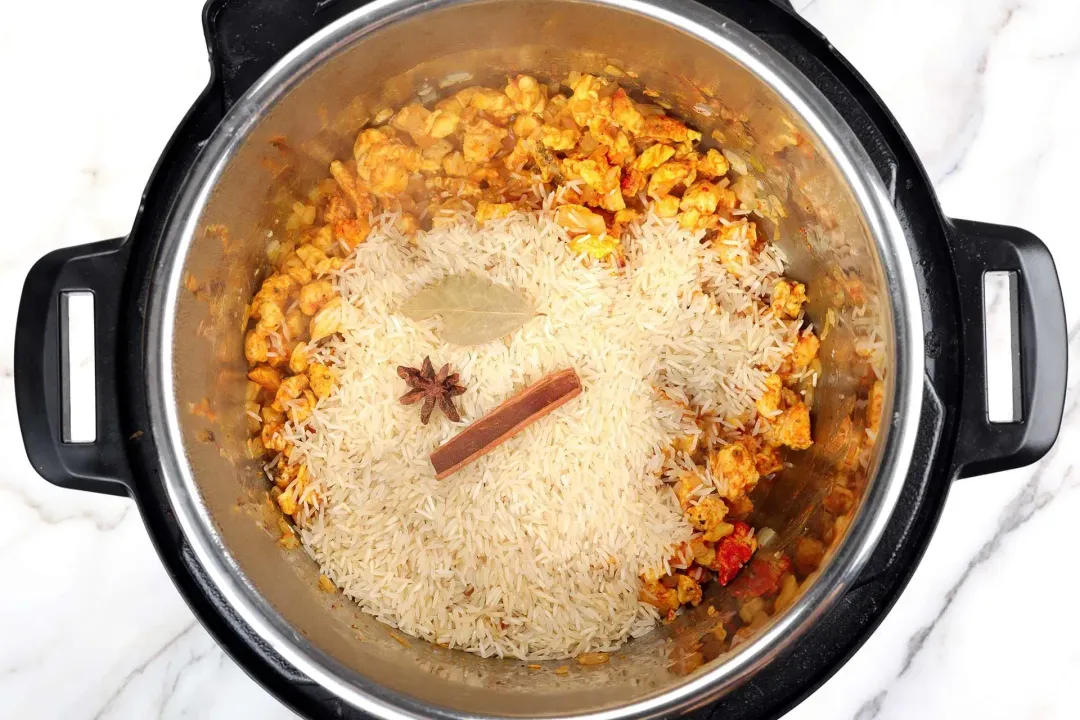 Add raw rice and whole spices instant pot biryani