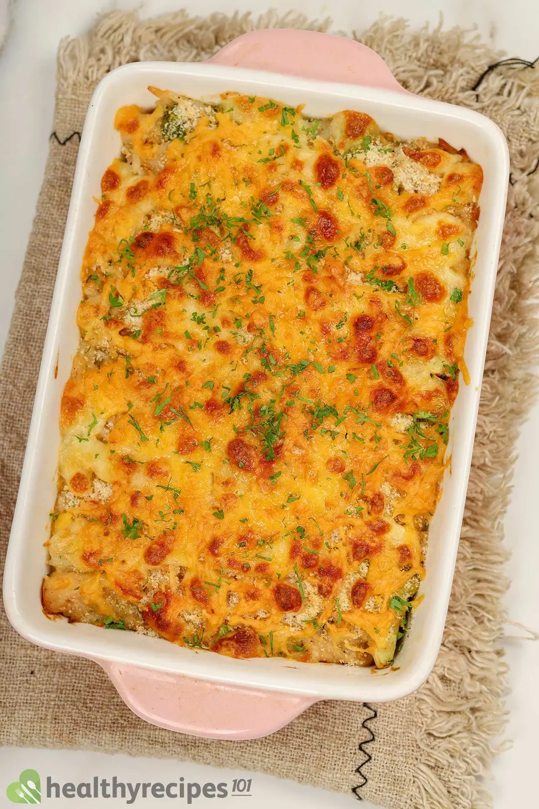 cooked chicken with cheese and chopped coriander on top in a casserole dish