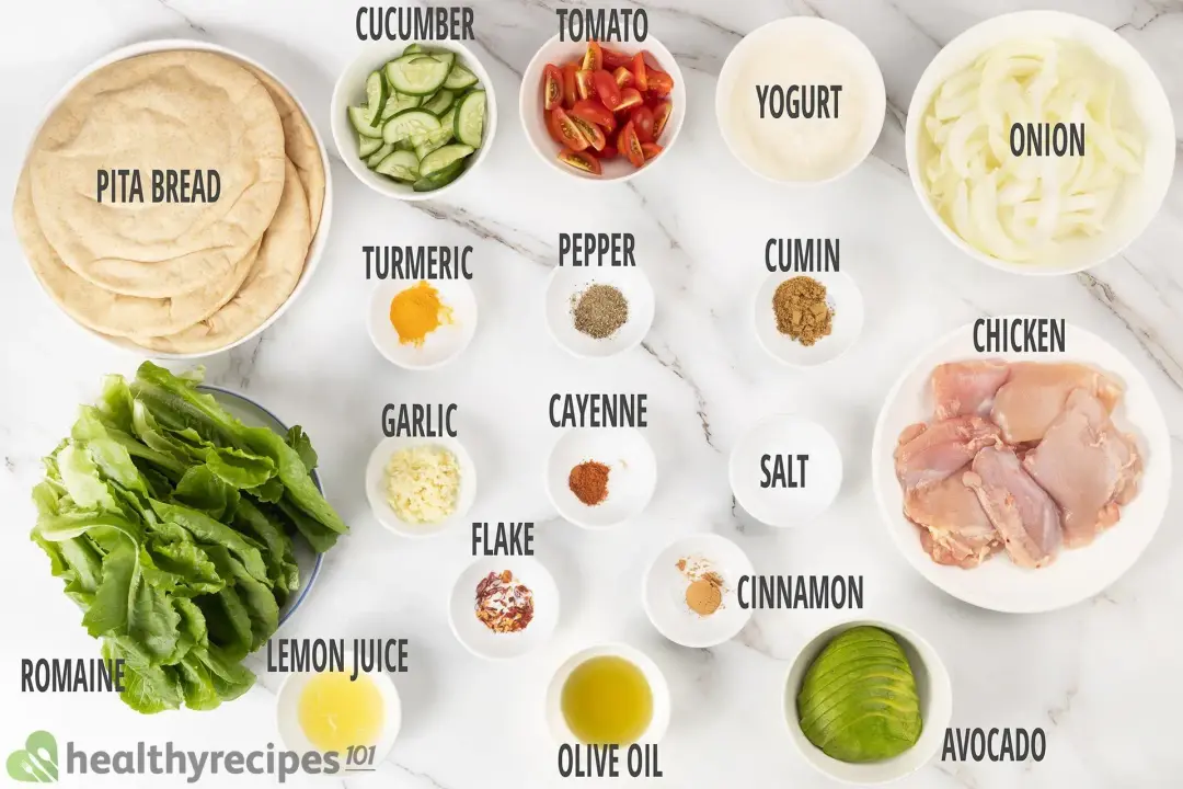 Ingredients with labels: pita bread, chicken breasts, cut-up vegetables and seasonings in different bowls
