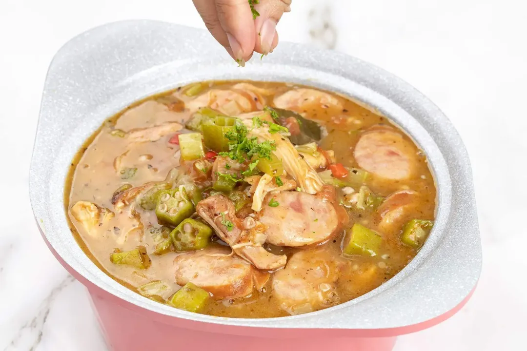 garnish and serve chicken and sausage gumbo