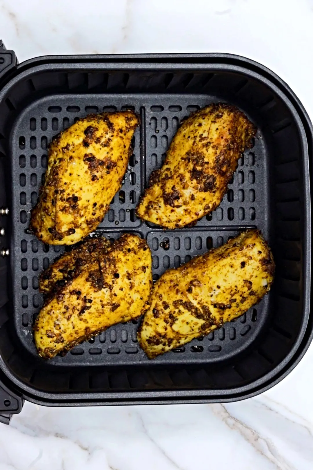 four chicken breasts in air fryer basket