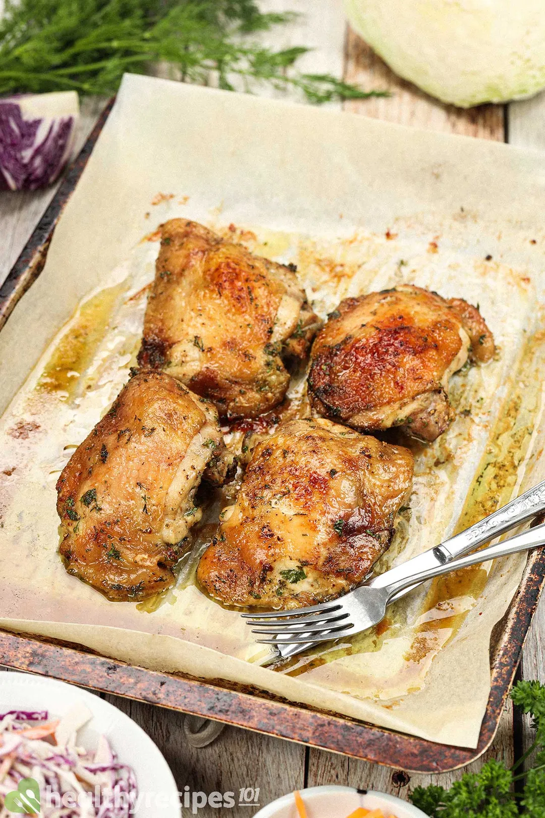 four cooked chicken thighs on a baking tray