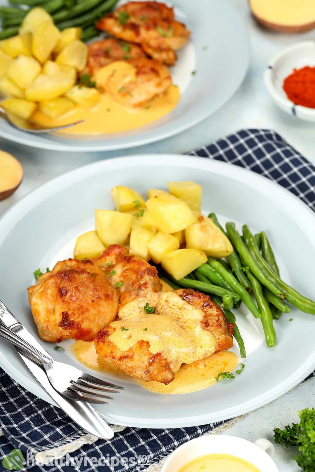 two plate of cooked chicken thighs