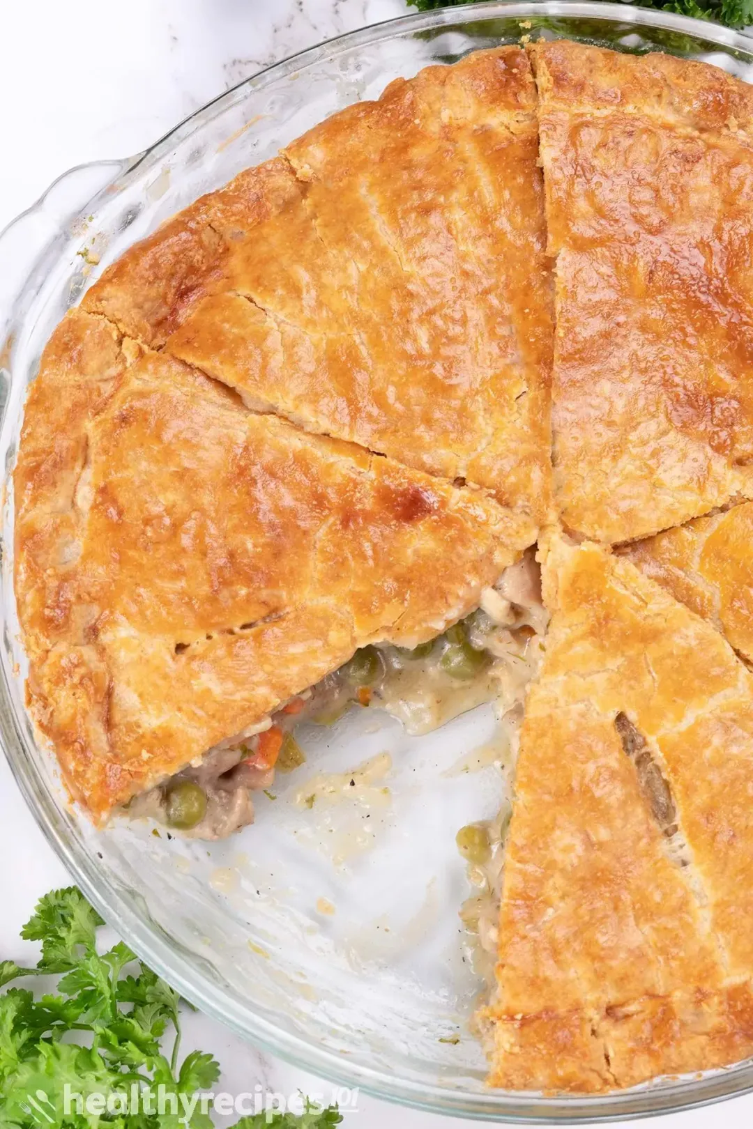 A chicken pot pie sliced into triangles with one missing piece