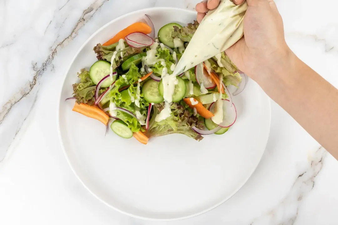 Layer the vegetables and drizzle the dressing over them