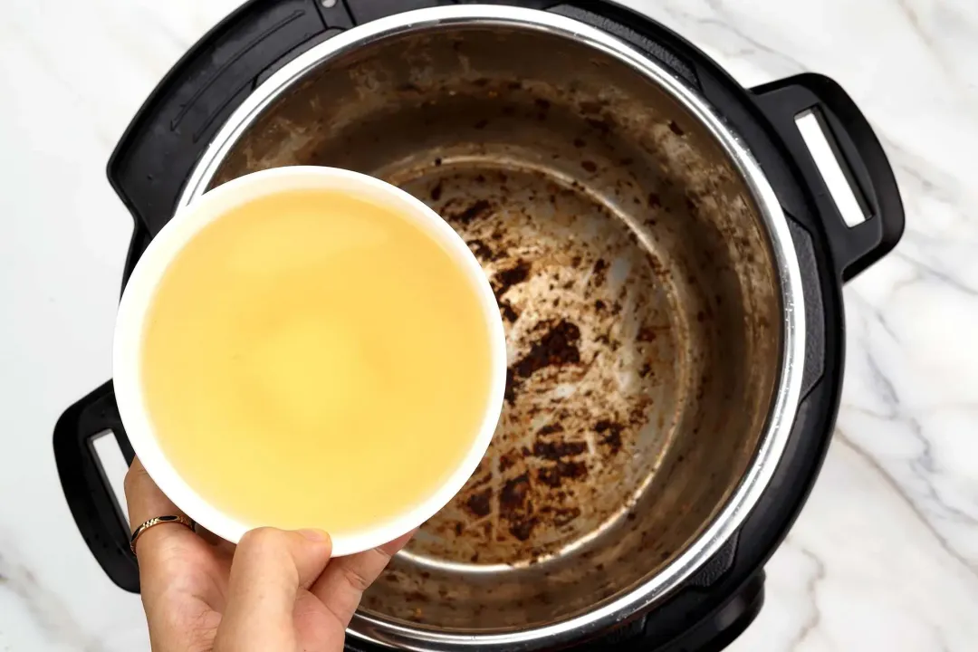 pour the 1 cup unsalted chicken broth into the pot