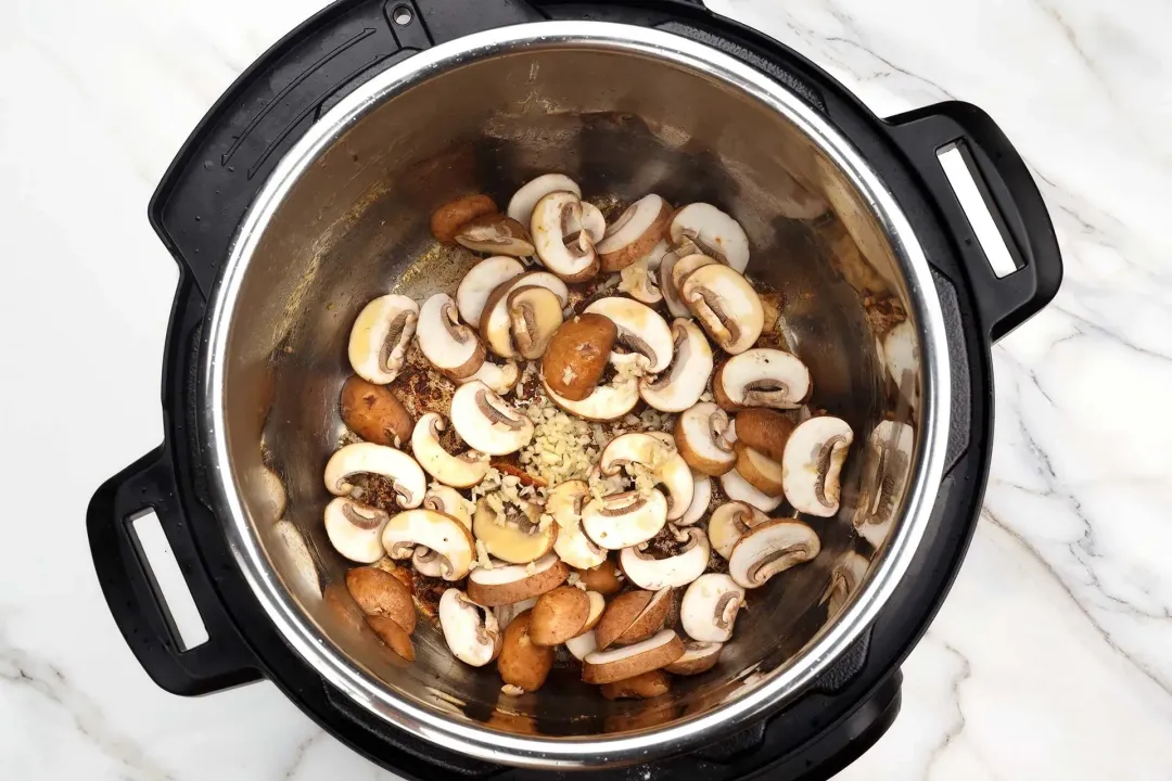 Saute butter cremini mushrooms and minced garlic until fragrant