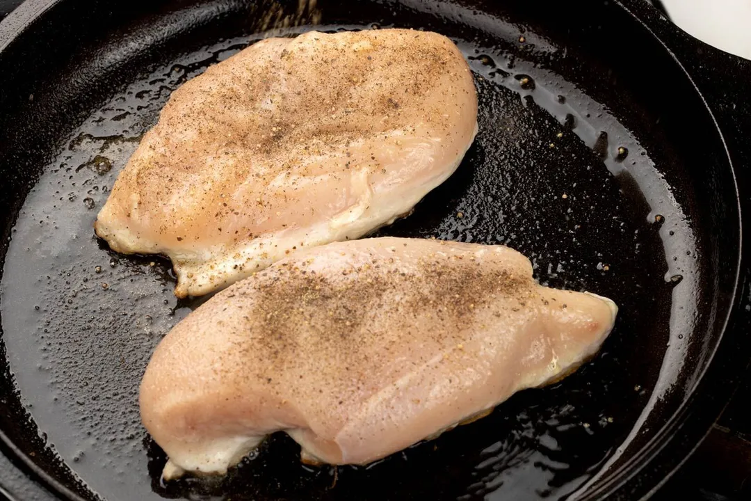 two chicken breasts in a cast iron skillet