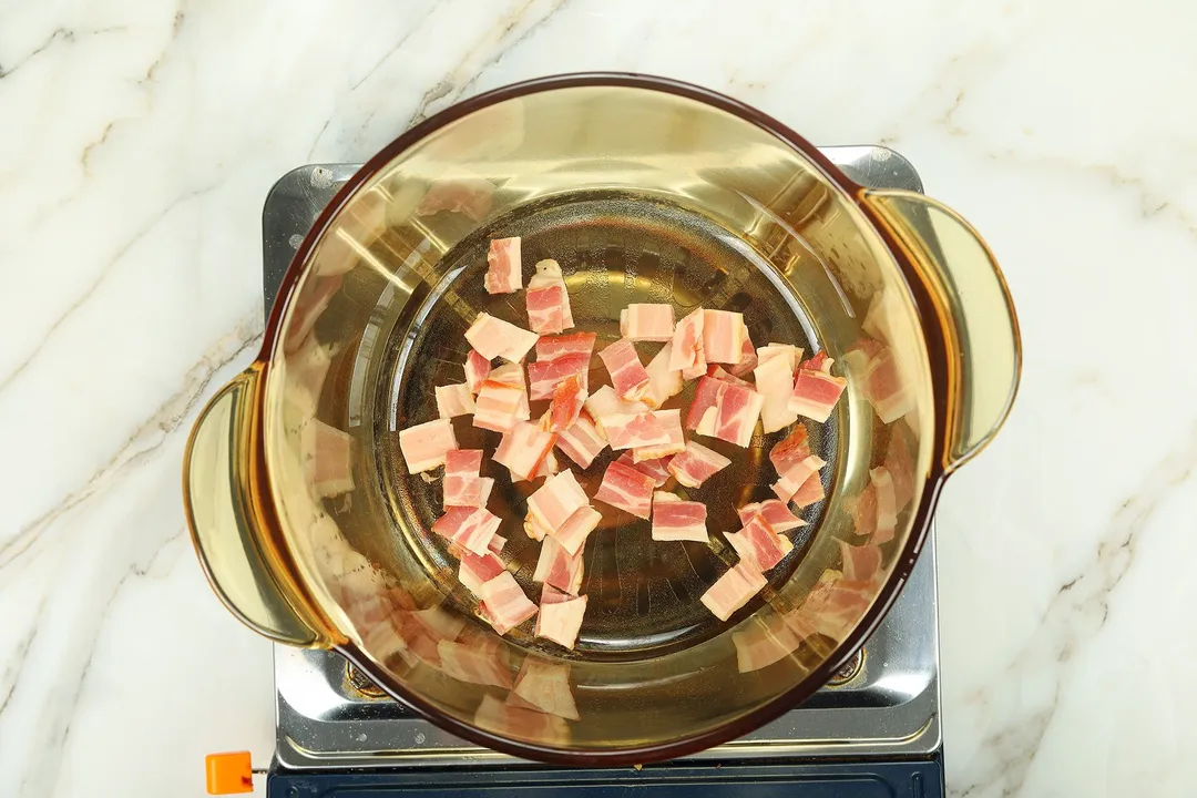 cooking bacon in a glass pot