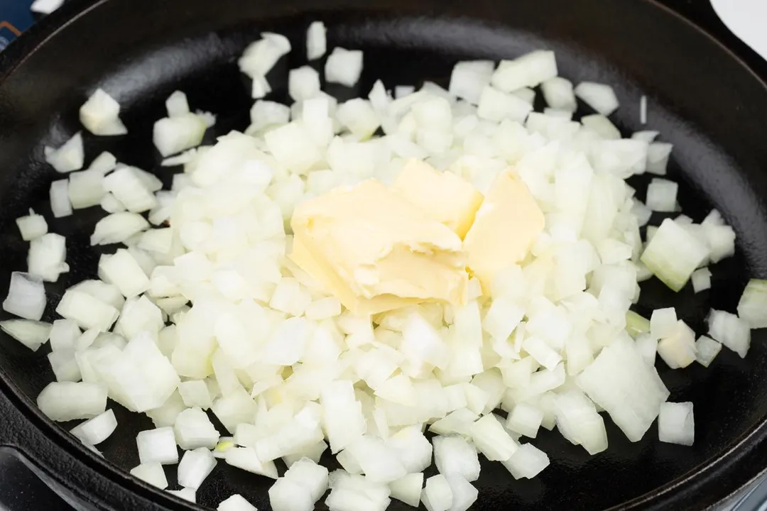 cooking diced onion with butter in a cast iron skillet