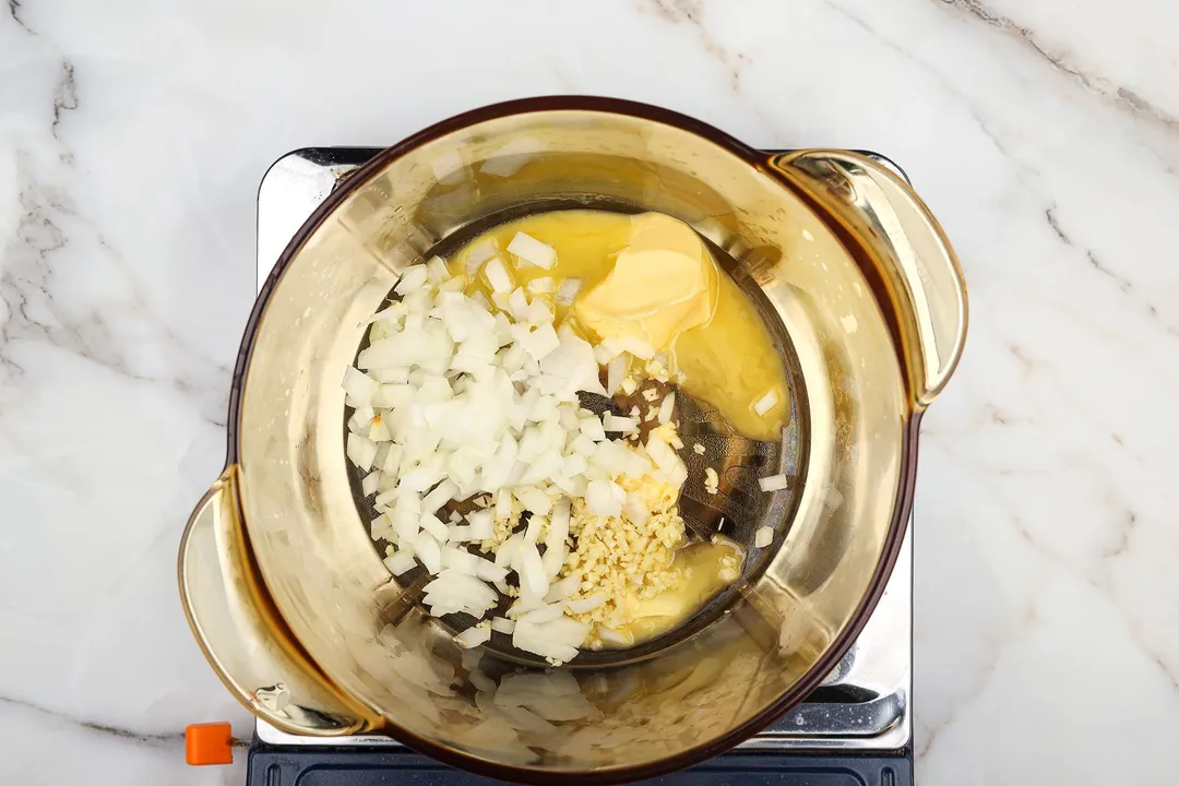 diced onion, garlic and butter cooking in a pot