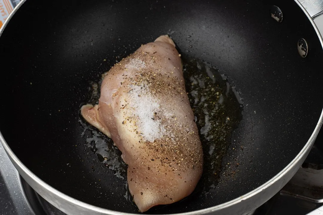chicken breast and pepper, salt in a skillet