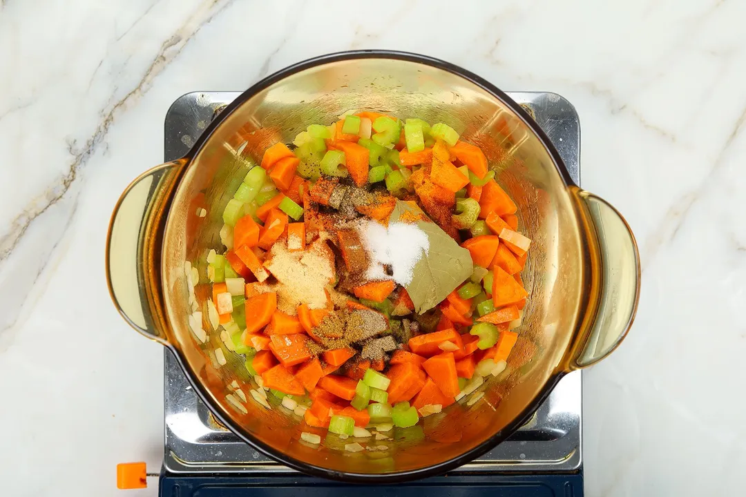 slices carrot celery and seasoning cooking in a pot