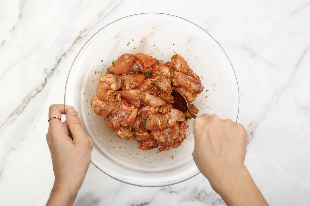 season chicken in a glass bowl