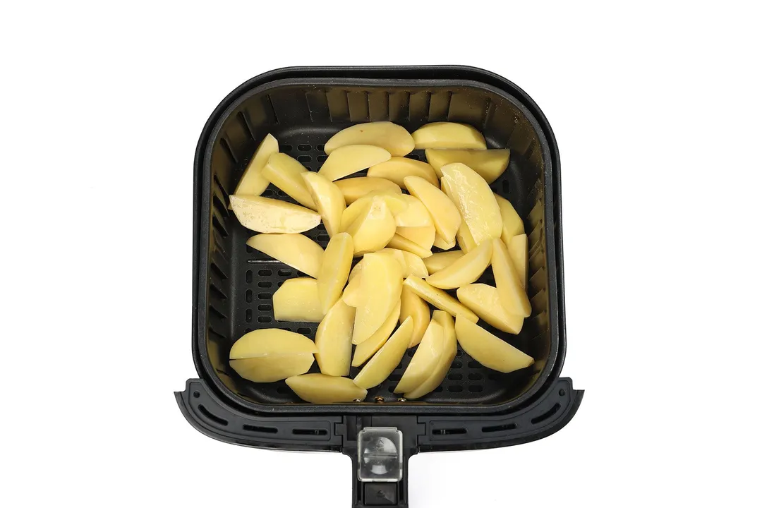 wedge potatoes in an air fryer basket