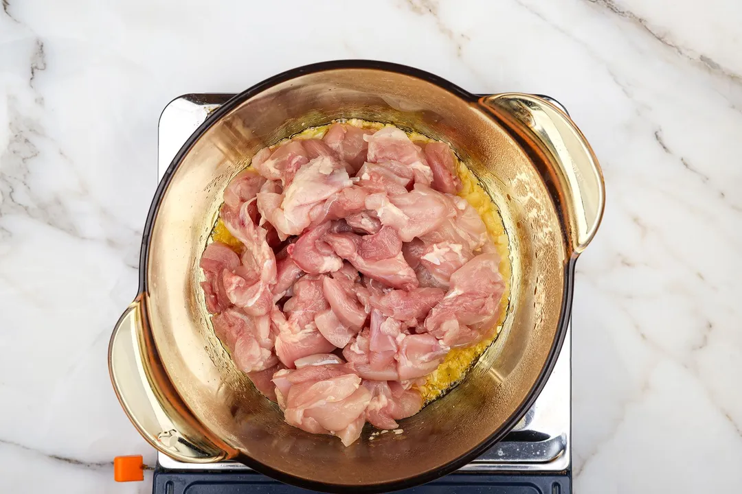 chicken slices cooking in a pot